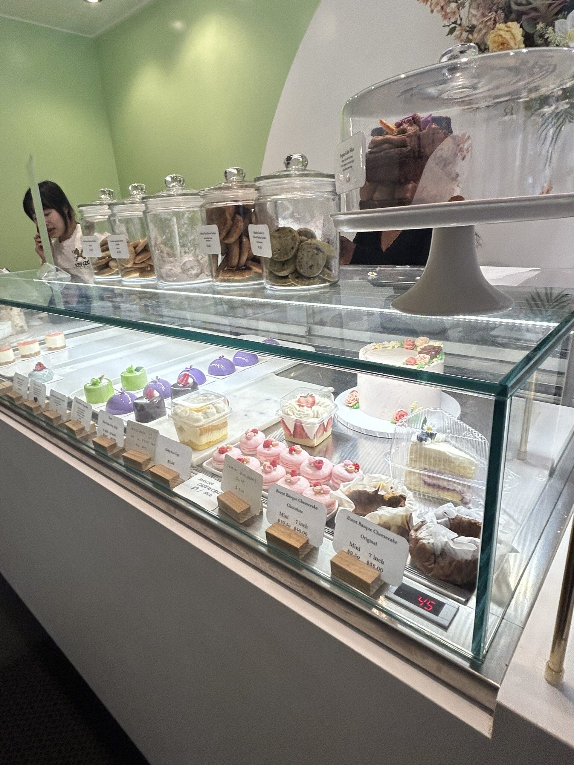 Display case with mirror glaze cakes